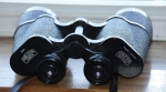 At magnifications over about 8x unless the binocular is tripod mounted, or with arms rested or the binocular is image stabilised, we are only going to catch glimpses of the fine detail that the instrument is capable of delivering. If you are standing and hand holding your binocular, I doubt you will see much more than a tantalising glimpse of finer detail at 12x than you would see at 6 or 7x. The smallest aid used to stabilise ones hold, will reveal finer detail when using the higher magnifications.Another important feature to come to grips with is what is called “eye relief.” No this is not two discs of cucumber it is the distance of your eye pupil from the glass in the eyepiece, when you are viewing the full field. If you wear spectacles all of the time, this is very important to you, as you need an eye relief of about 17mm, to accommodate the bulk of the spectacle lens between you and the binocular eyepiece. Check this distance on the specification list for any binocular you intend to buy. Vintage binoculars with extra wide field generally have just enough eye relief to observe the full field when not wearing glasses. Zeiss 10 x 50, excellent bins but annoying fixed eye-cups.